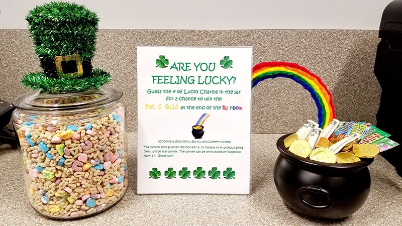 St. Patrick's Day themed orthodontic office display with lucky charm decorations and "Are You Feeling Lucky?" promotional sign.