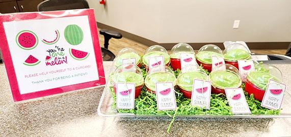 Orthodontic office display featuring pink instruction chart and colorful treat boxes on carpeted floor.